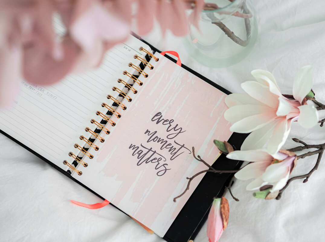 Printed weekly planner and folders on a desk
